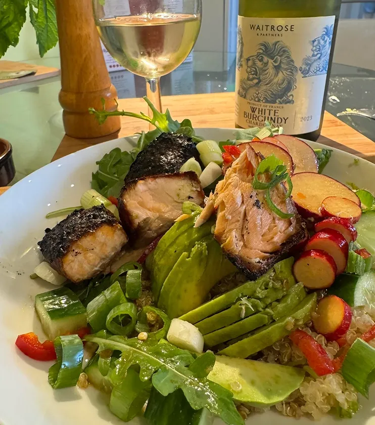 Seared fresh fish served with avocado, salad and quinoa.