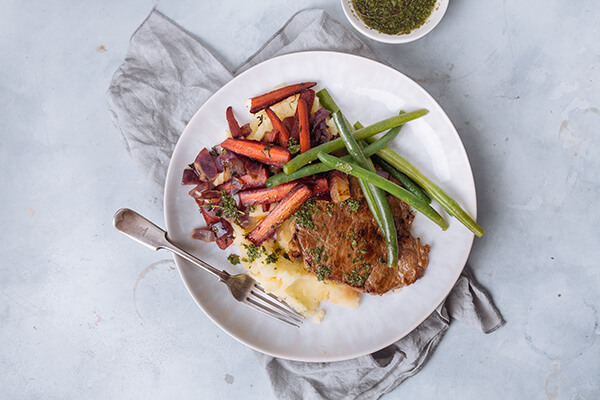 Lamb steak with mint sauce, parsnip mash & roasted purple carrots
