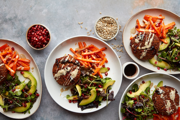 Lentil burger with avocado, salad, and tahini